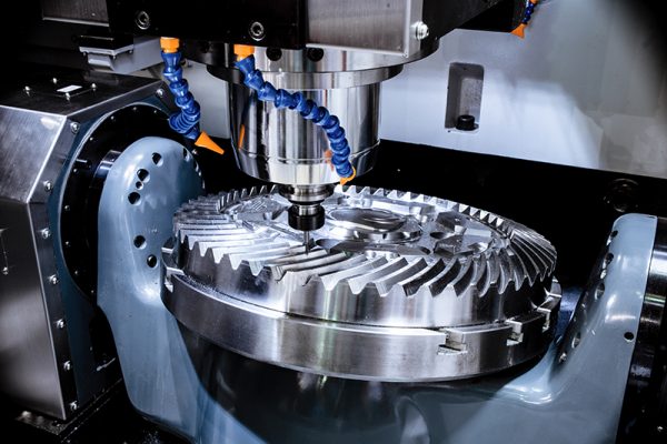 A modern CNC milling machine makes a large cogwheel